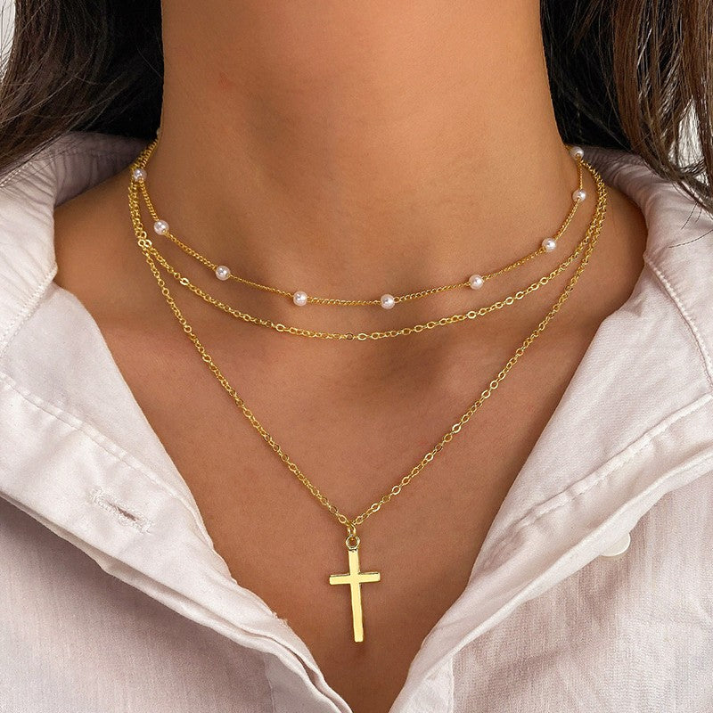 Gold necklaces with a cross pendant