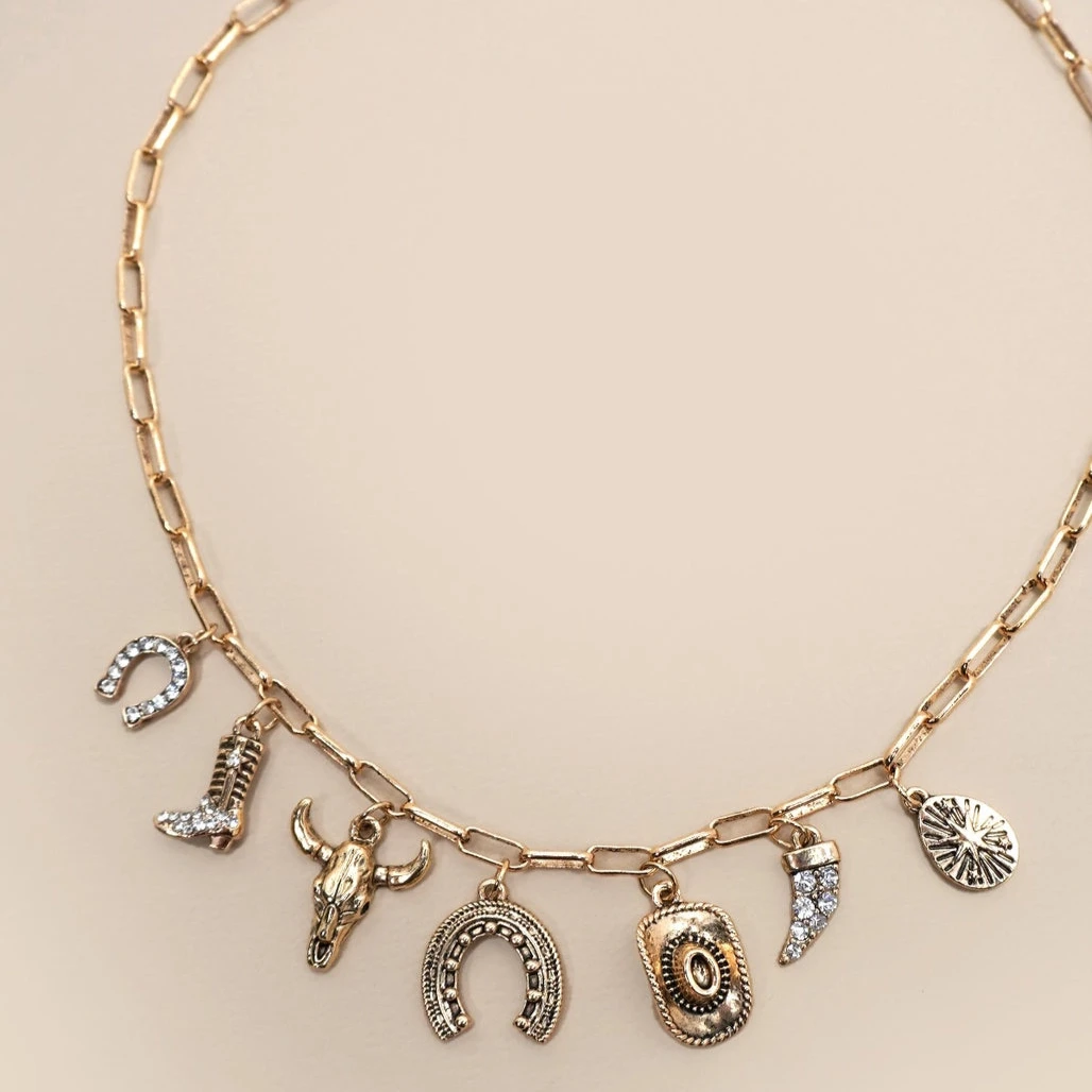 Necklace with various charms on a beige background