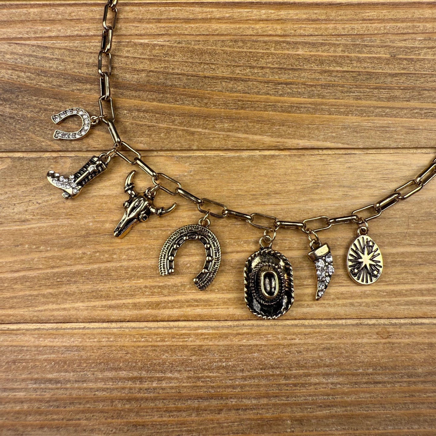 Necklace with various charms on a wooden surface