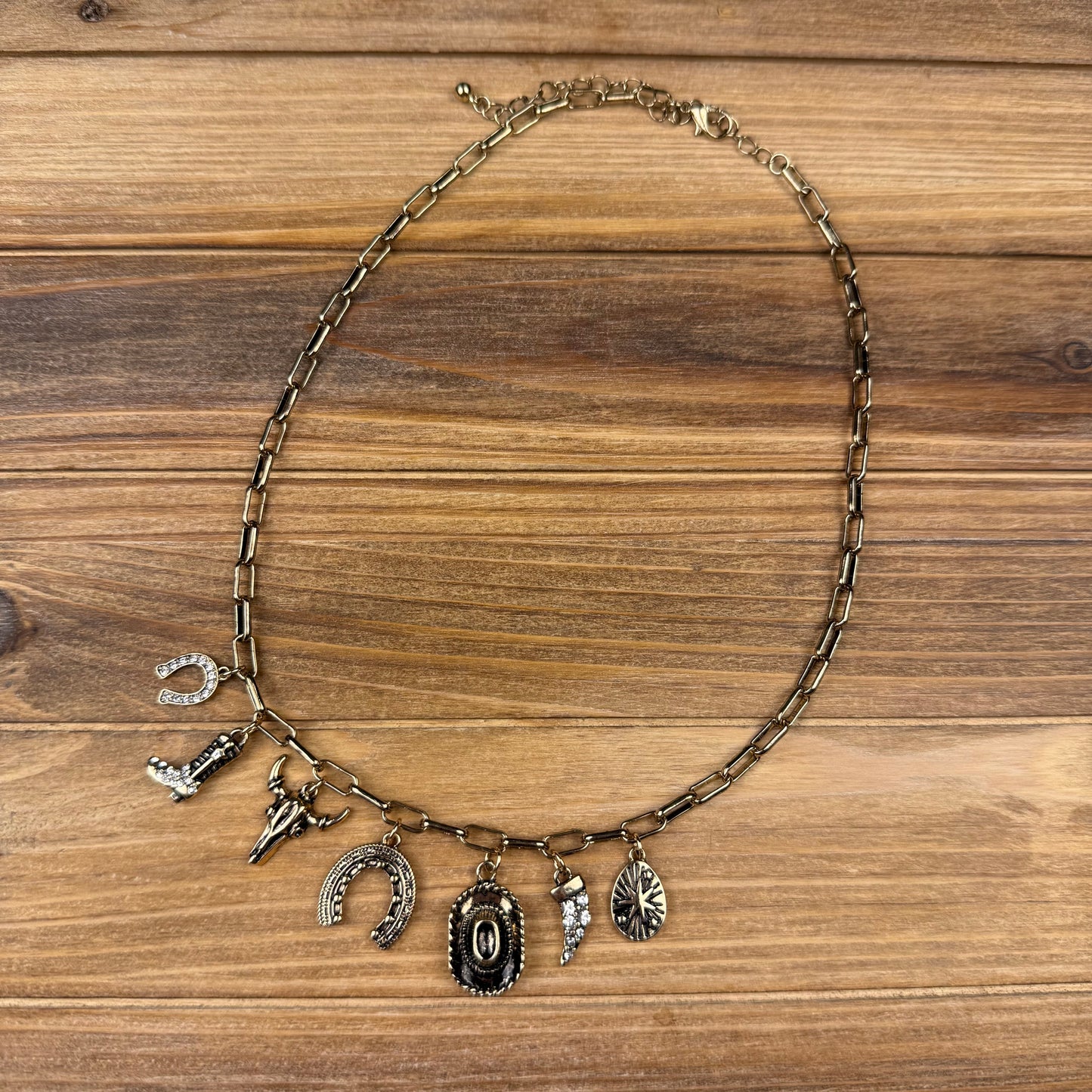 Necklace with various charms on a wooden surface