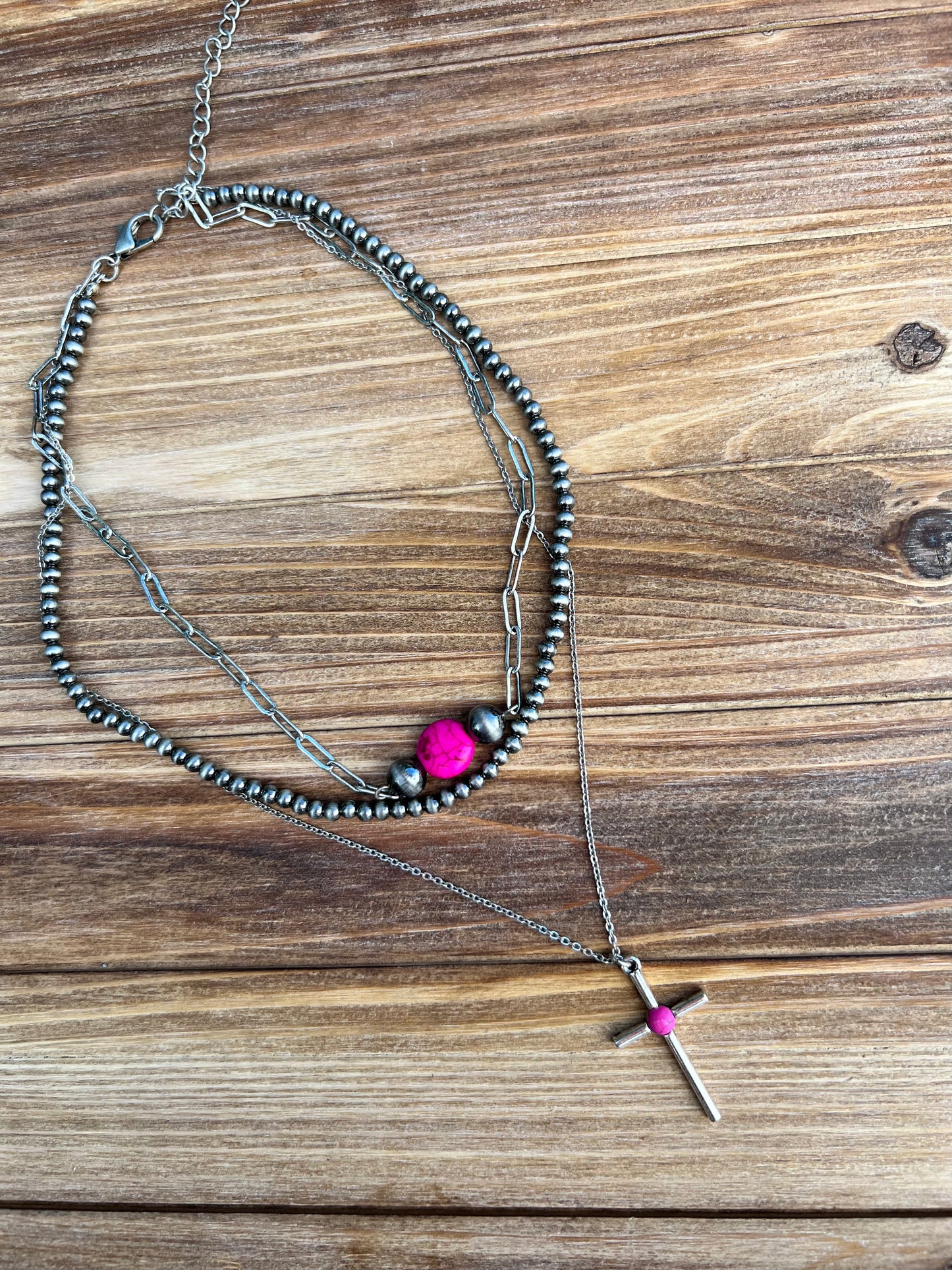 Faux hot pink turquoise, silver and navajo pearl necklace. Western style jewelry. Necklace is shown as a layered stack but is still one individual necklace. Western faux turquoise jewelry