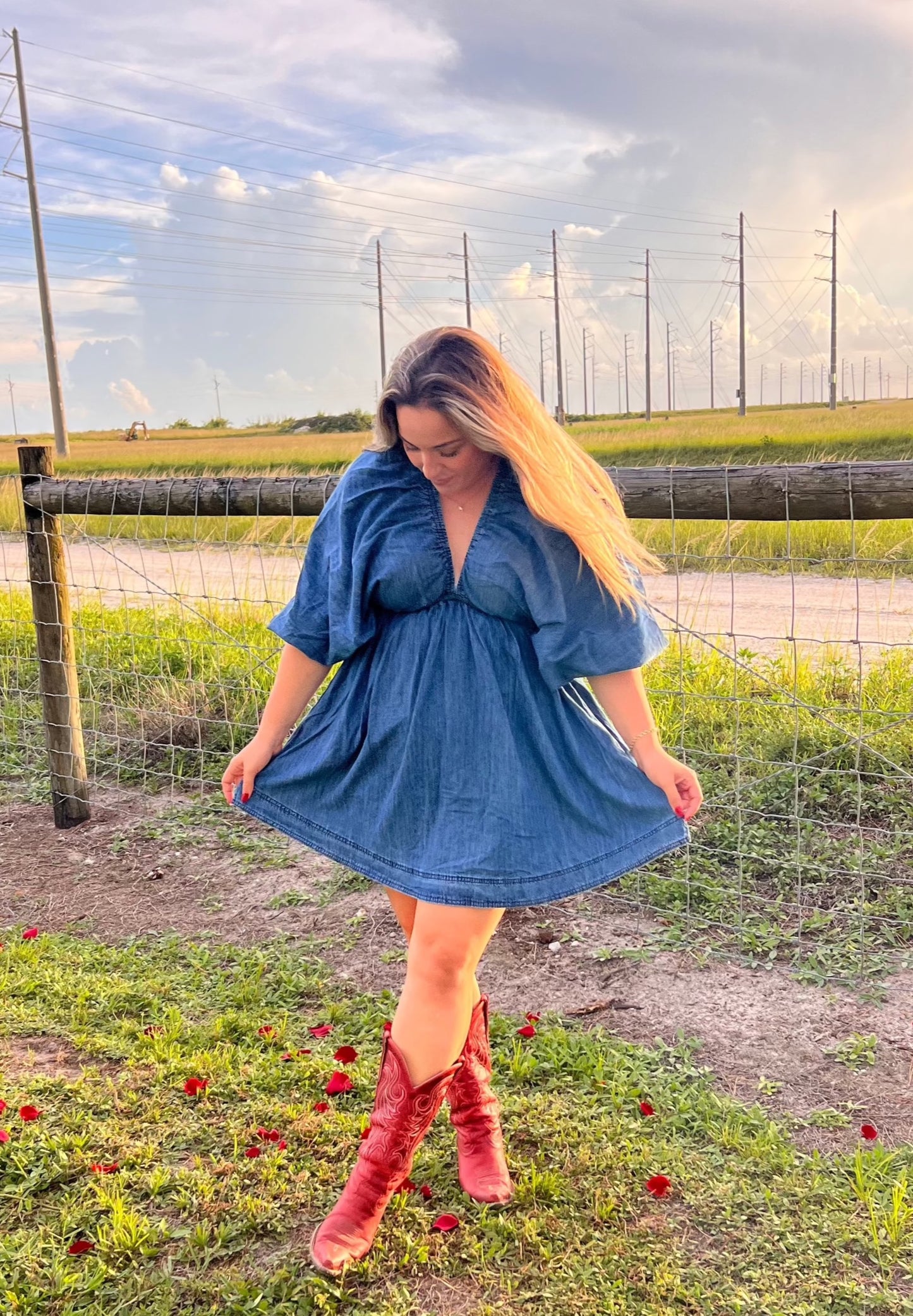 Women's denim mini dress with red cowboy boots