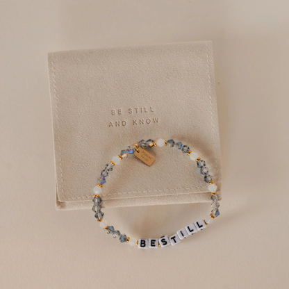 Beaded bracelet with 'Be Still and Know' message on a beige background
