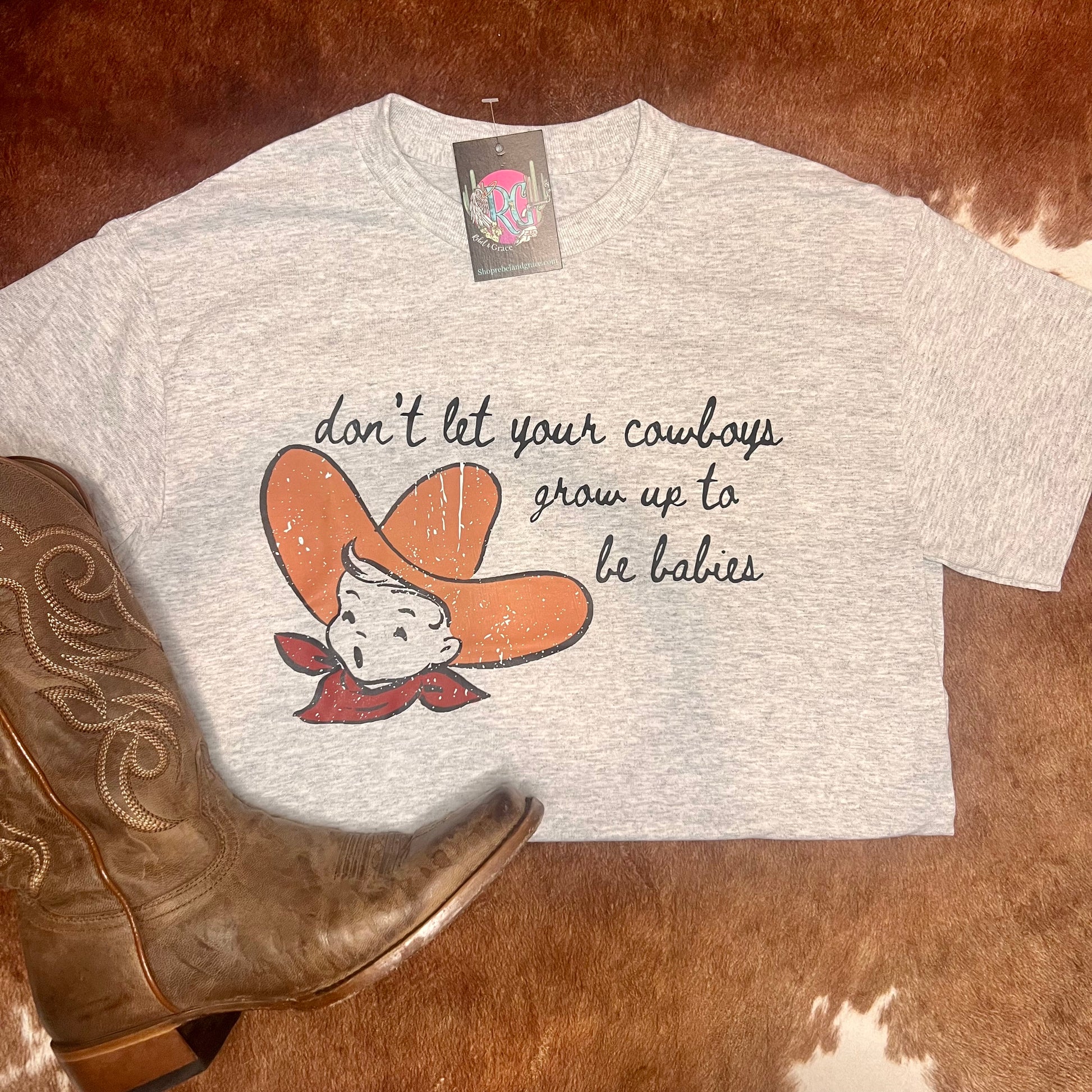 Gildan t-shirt in light heathered gray with quote don't let your cowboys grow up to be babies from cody johnson song with a baby cowboy on it