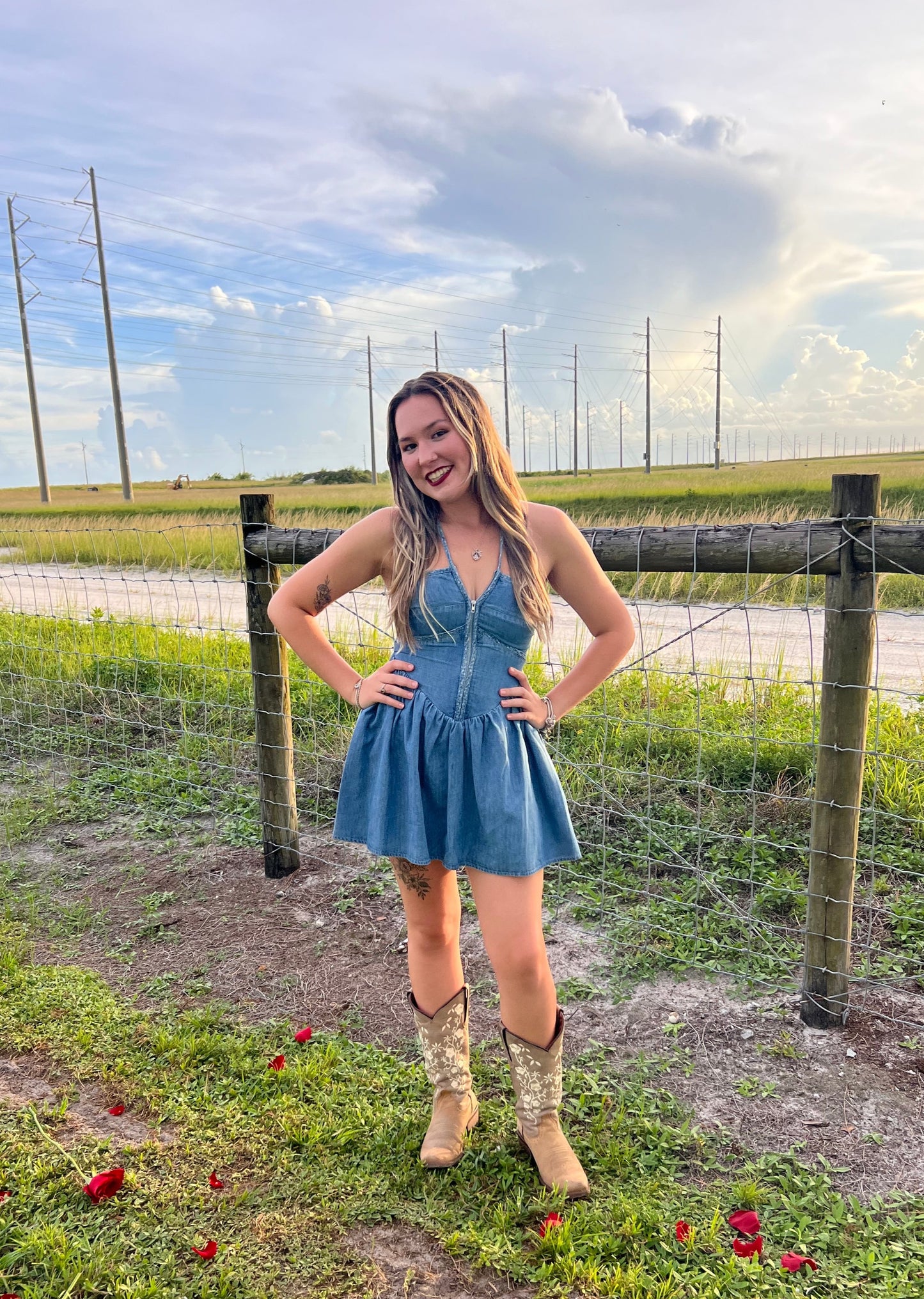 Denim mini dress romper paired with cowgirl boots