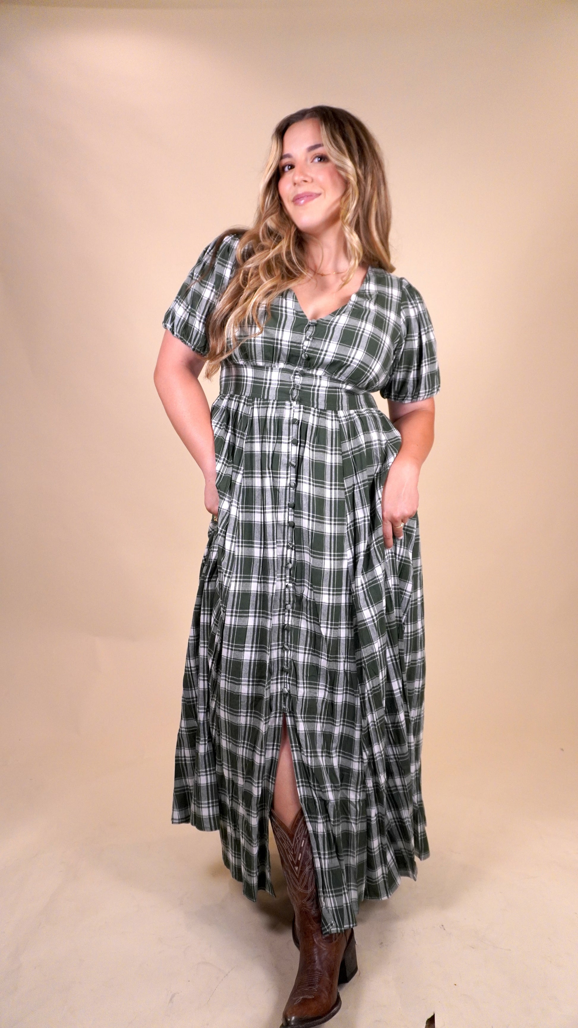 women wearing a plaid green and white dress with a v-neck and buttons down the front. Perfect dress for a christmas dinner or fall and winter church services.