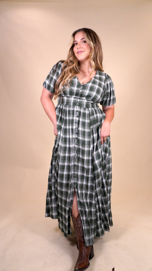 women wearing a plaid green and white dress with a v-neck and buttons down the front. Perfect dress for a christmas dinner or fall and winter church services.