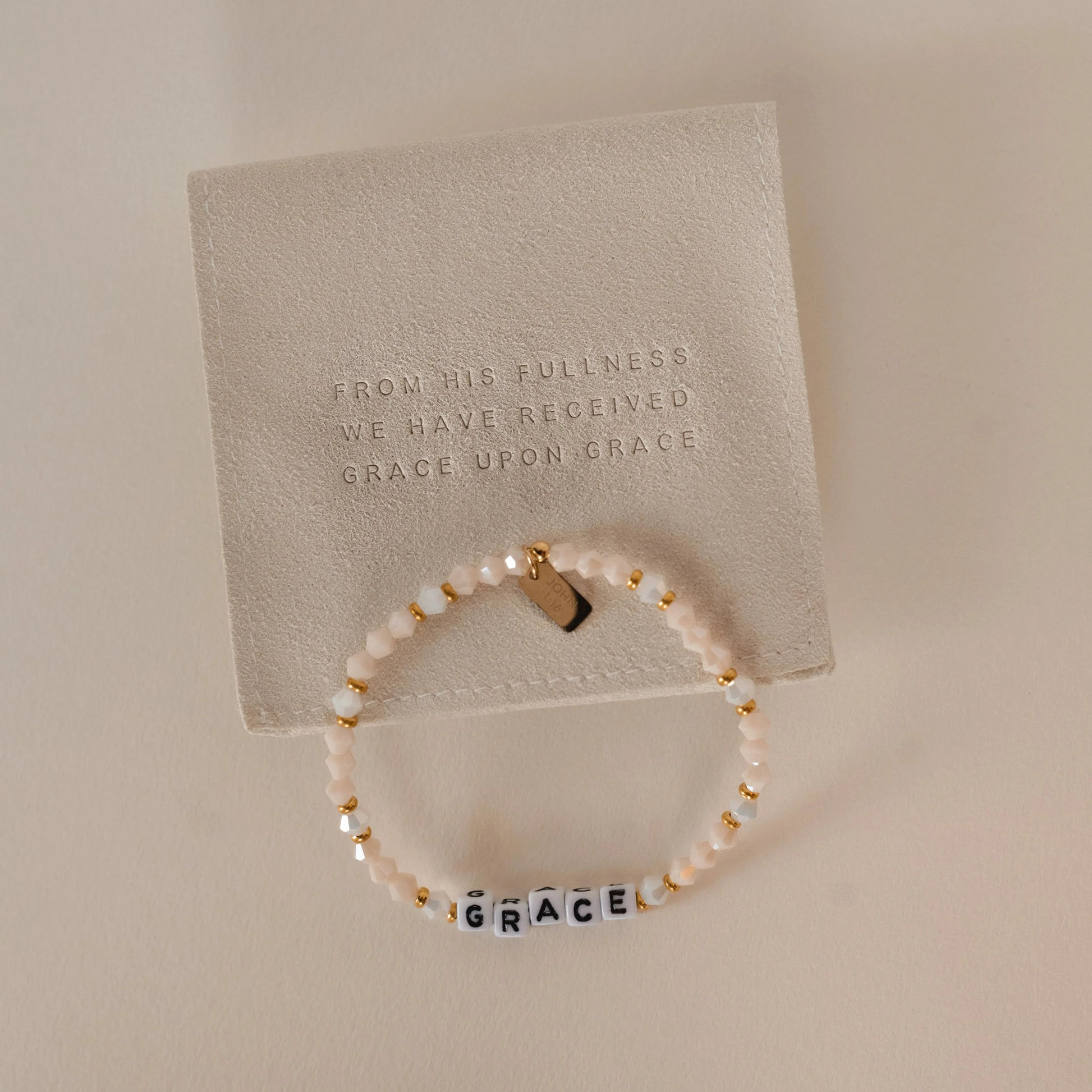 beaded bracelet with word GRACE on it and a gold tag with a bible verse. Christian women's jewelry. Faith based jewelry.