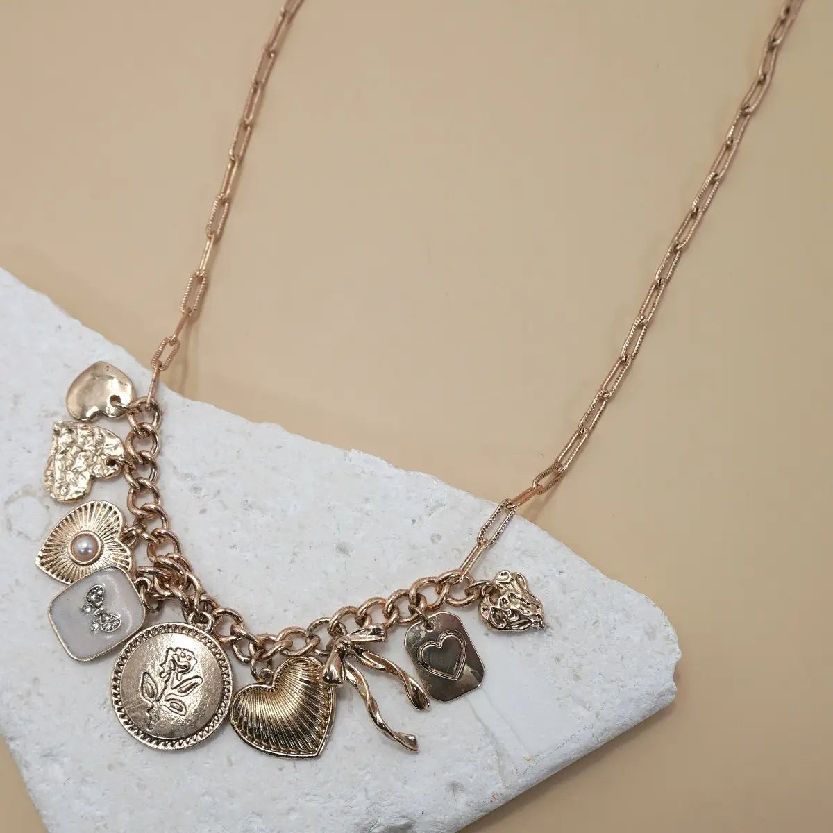 Gold necklace with feminine and girly charm. Trendy women's charm necklace.