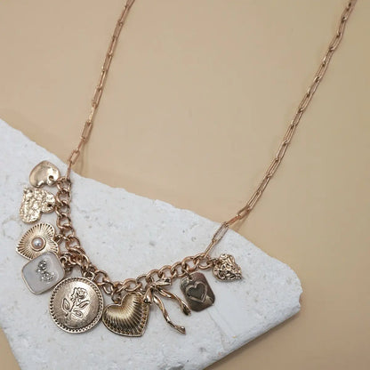 Gold necklace with feminine and girly charm. Trendy women's charm necklace.