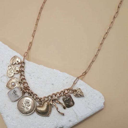 Gold necklace with feminine and girly charm. Trendy women's charm necklace.