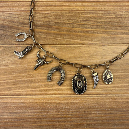 Necklace with various charms on a wooden surface