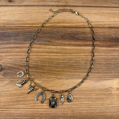 Necklace with various charms on a wooden surface