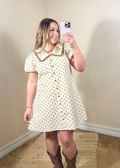 Ivory and brown polka dot mini dress styled with cowboy boots for a feminine fall outfit.