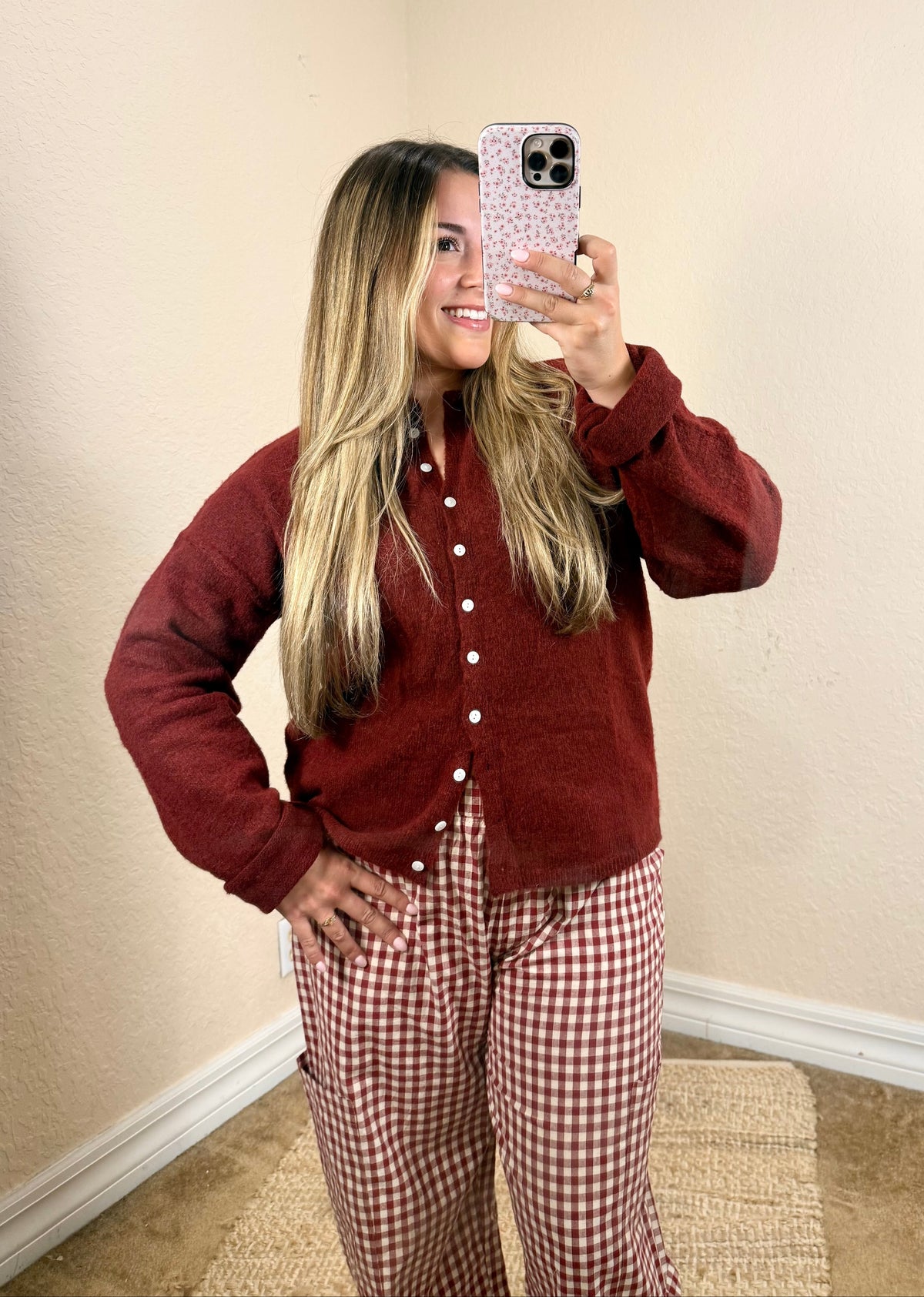 Woman wearing a burgundy button cardigan with plaid pants for a feminine fall outfit