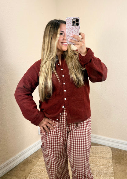Woman wearing a burgundy button cardigan with plaid pants for a feminine fall outfit