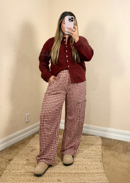 Woman wearing cherry red gingham pants with a burgundy cardigan for a fall outfit