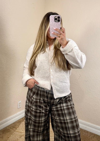 Close-up of soft oatmeal cardigan with front button detail