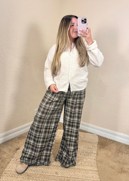 cream colored button down cardigan paired with brown plaid trousers