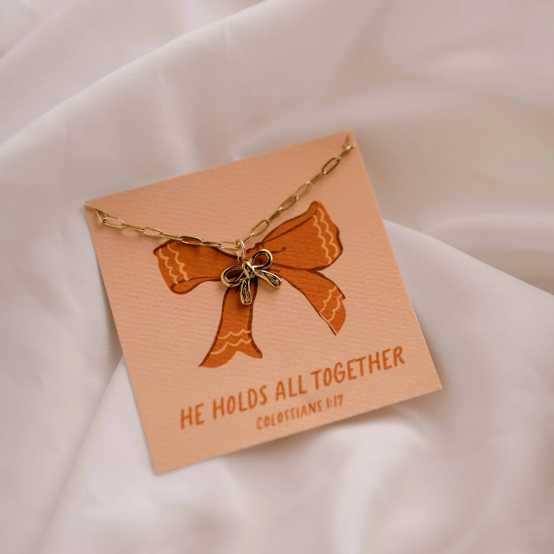 christian faith inspired charm necklace with bow detail.