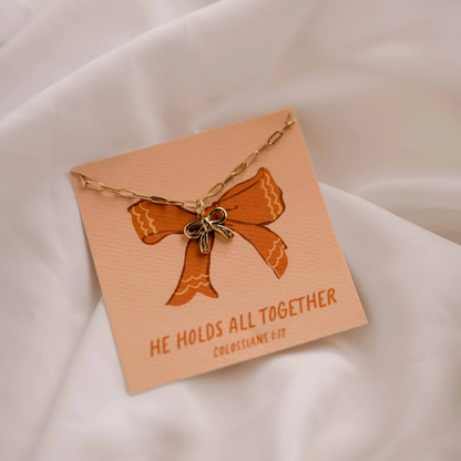 christian faith inspired charm necklace with bow detail.