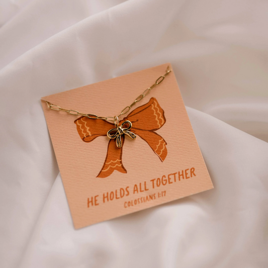 christian faith inspired charm necklace with bow detail.