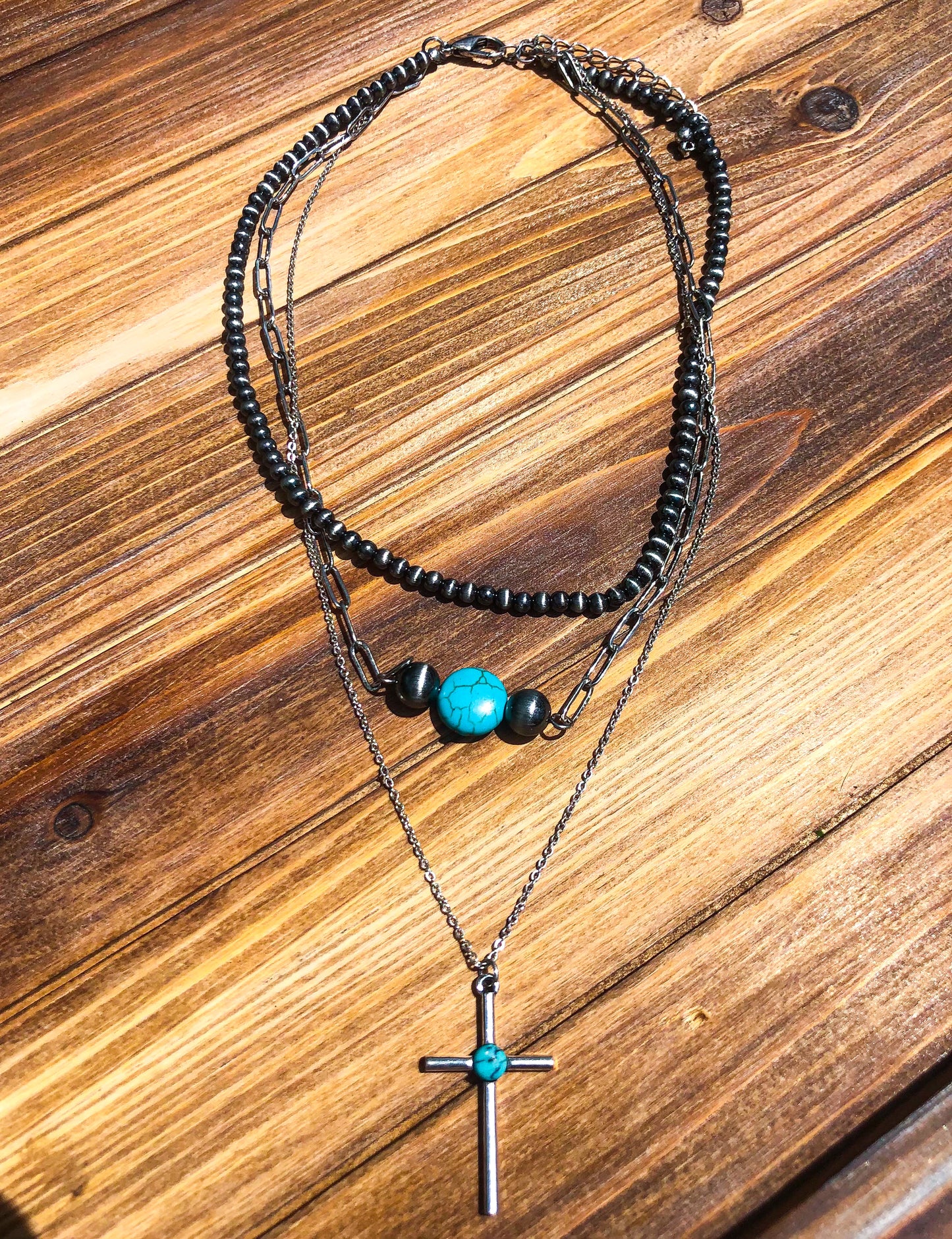 Faux turquoise, silver and Navajo pearl necklace. Western style jewelry. Necklace is shown as a layered stack but is still one individual necklace. Faux Western turquoise jewelry