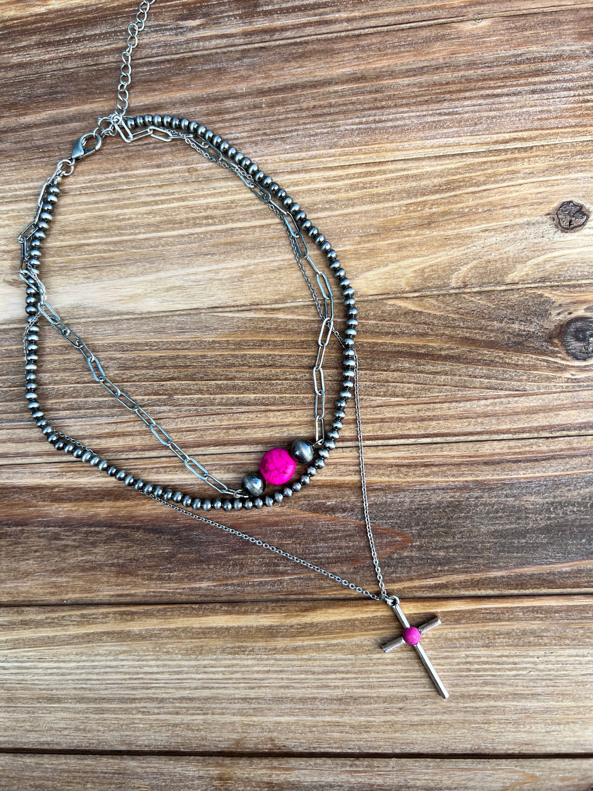 Faux hot pink turquoise, silver and navajo pearl necklace. Western style jewelry. Necklace is shown as a layered stack but is still one individual necklace. Western faux turquoise jewelry 